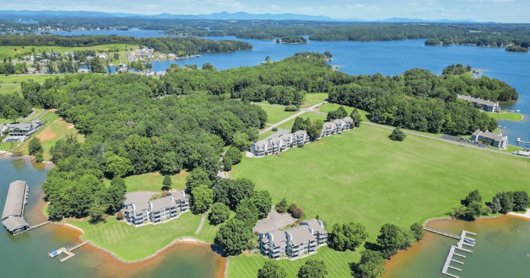 An aerial view of condos, green space, lake and mountains at Bernard's Landing at Smith Mountain Lake, VA.