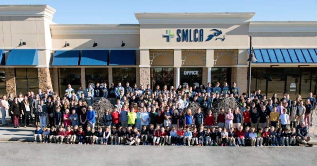 Students and teachers gather outside SML Christian Academy.