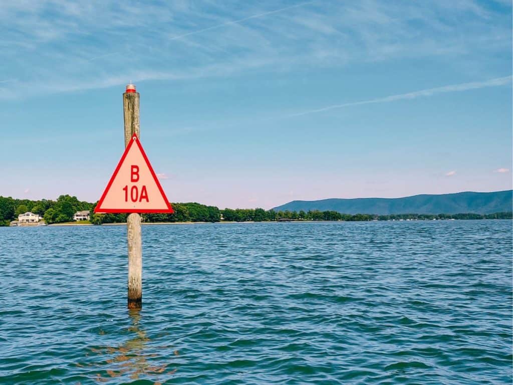 Red triangle channel marker B10A with Smith Mountain in the background
