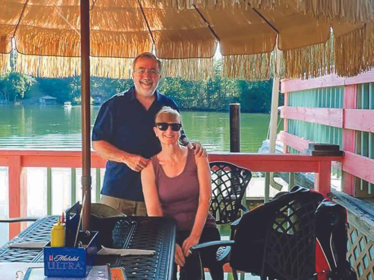 Brian and Lisa Raub on deck overlooking the water