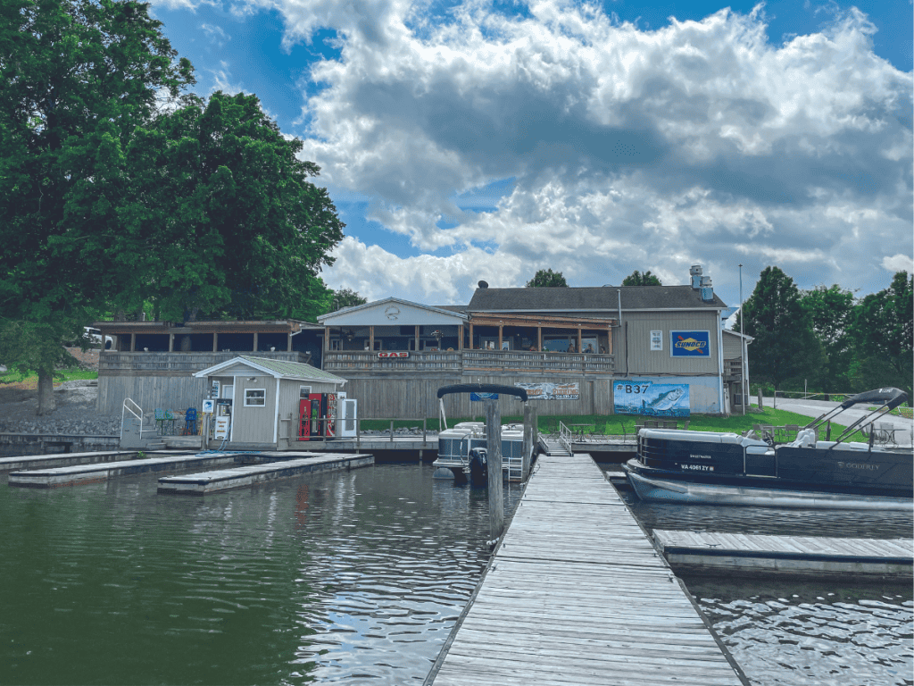 Exterior lakeside of Magnum Point Marina with dock leading up to restaurant.